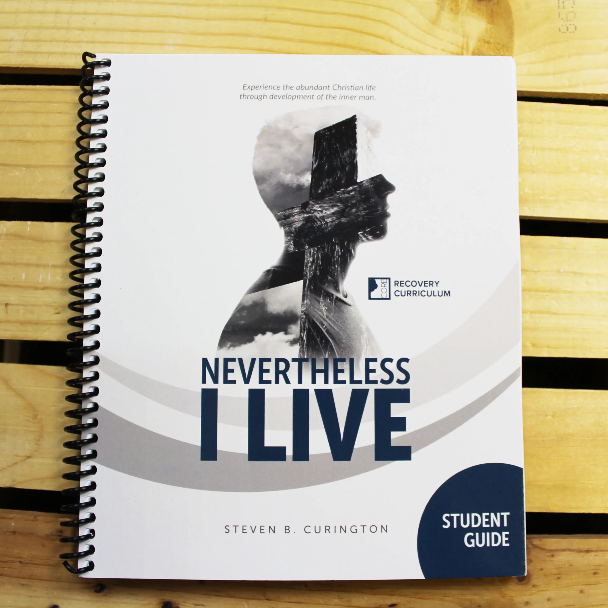 Nevertheless, I Live student guide on a wood tabletop